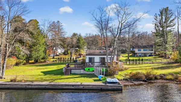 a view of a swimming pool with lawn chairs and a yard