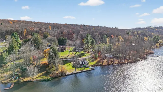a view of a wooden deck with chairs and wooden fence