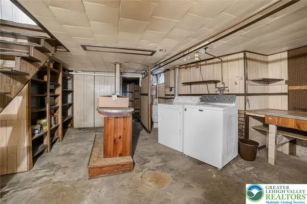 a view of a storage room with air conditioner duct and materials on floor