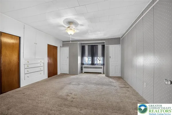 a view of an empty room with a window