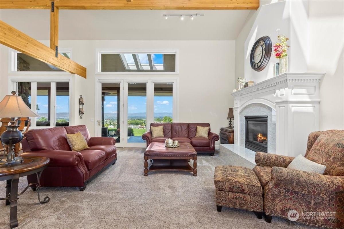 201 Wendt Road Yakima, WA 98901 - Photo 3 of 32 a living room with furniture a fireplace and a large window