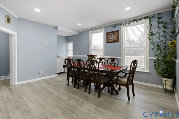 a view of a dining room with furniture and wooden floor
