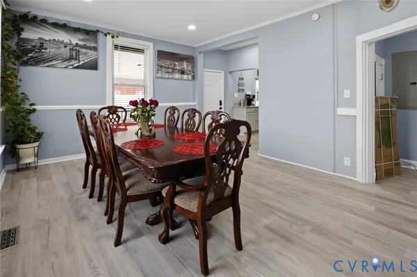 a view of a dining room with furniture and wooden floor