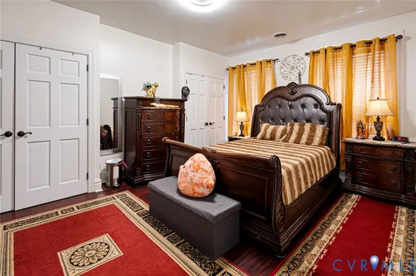 a bedroom with a bed and a mirror