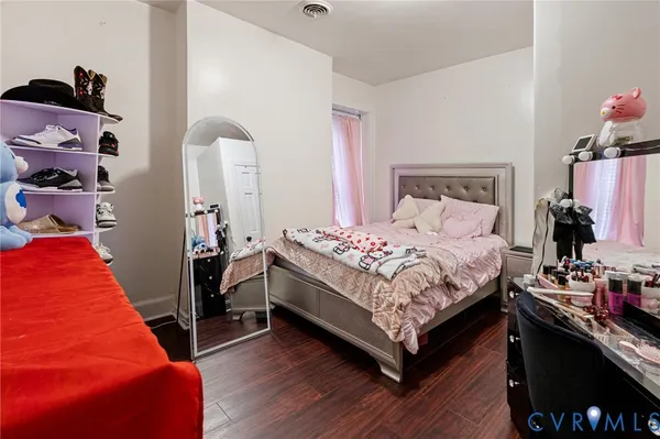 a view of a house with a large space and a car parked in front of it