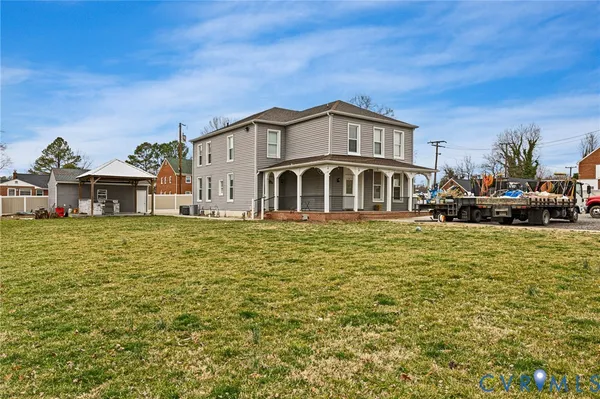 a view of a house with a large space and a car parked beside it