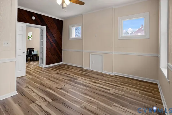 wooden floor in an empty room with a window