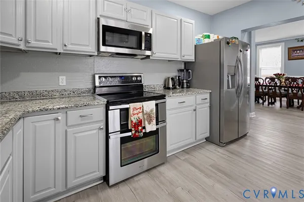 a view of a dining room with furniture and wooden floor