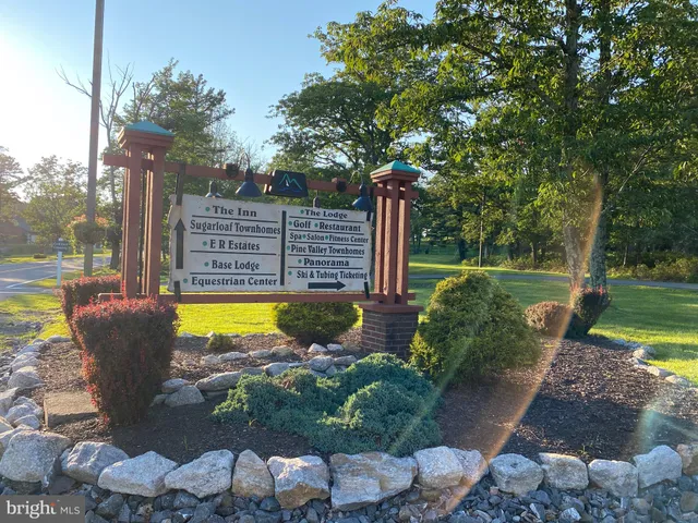 a view of a swimming pool with a patio and a yard