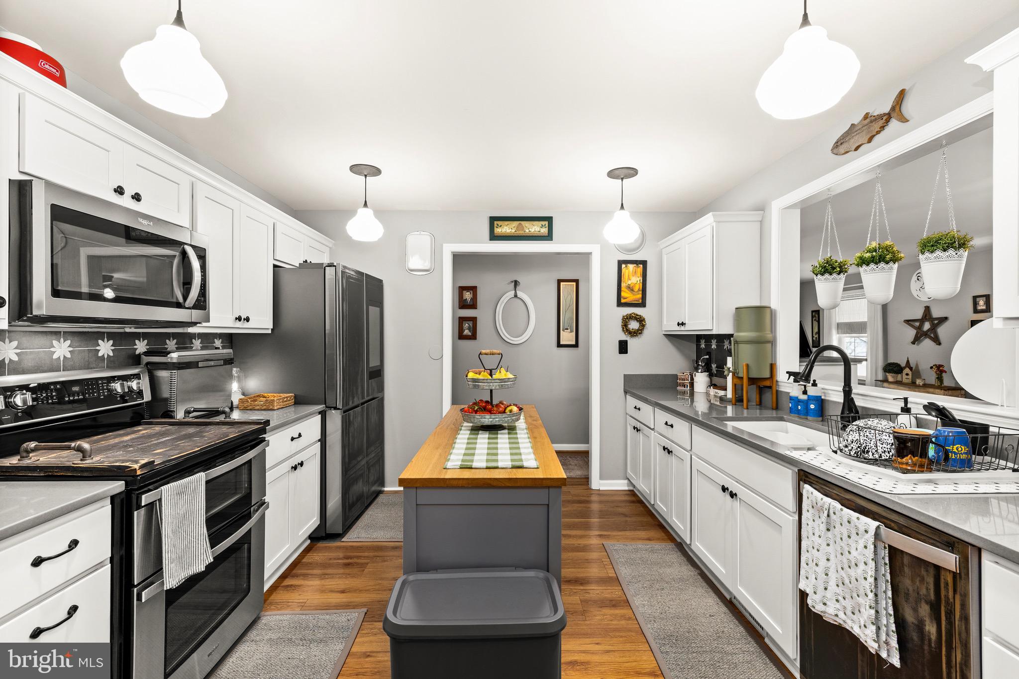 30367 Old Locust Grove Locust Grove, VA 22508 - Photo 25 of 36 a large kitchen with stainless steel appliances lots of counter space and wooden floors