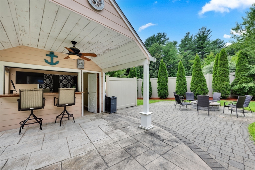 9 Vincent Road Mendon, MA 01756 - Photo 29 of 36 a view of a patio with table and chairs under an umbrella with a barbeque