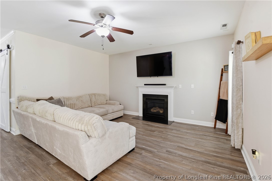 140 Birch Avenue Spring Lake, NC 28390 - Photo 16 of 49 a living room with furniture a fireplace and a flat screen tv