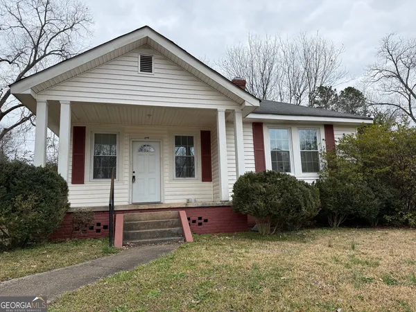 a front view of a house with garden