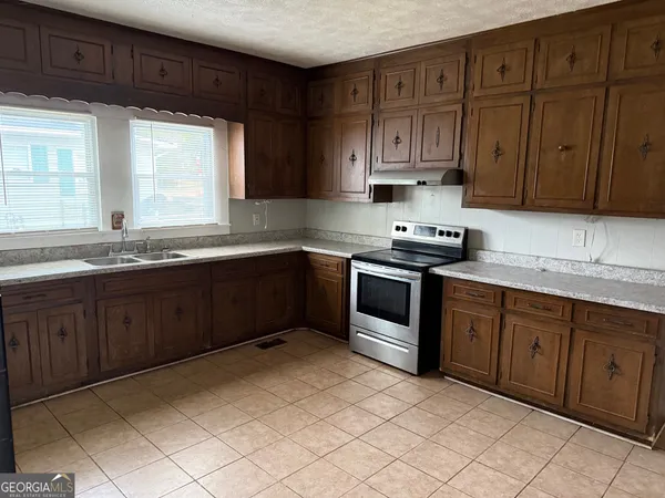 a kitchen with stainless steel appliances granite countertop a sink and cabinets