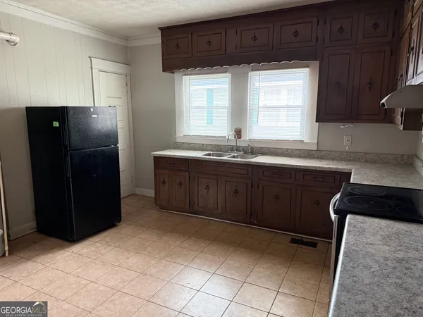 a kitchen with stainless steel appliances granite countertop a refrigerator and a sink
