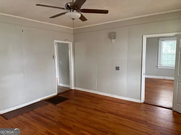 a view of an empty room with wooden floor