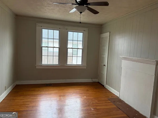 wooden floor in an empty room with a window