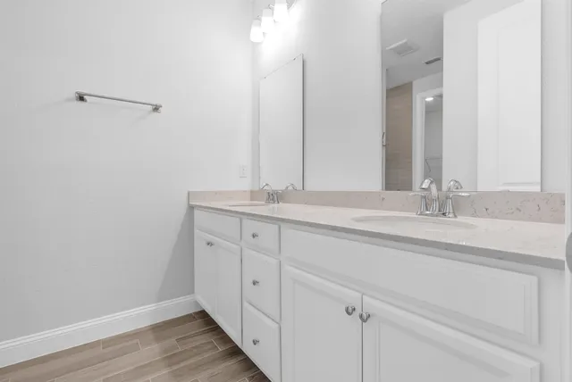 a bathroom with a sink a vanity and a mirror