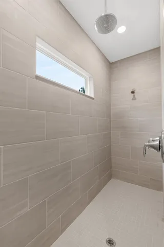 a bathroom with a sink a toilet a shower and a mirror