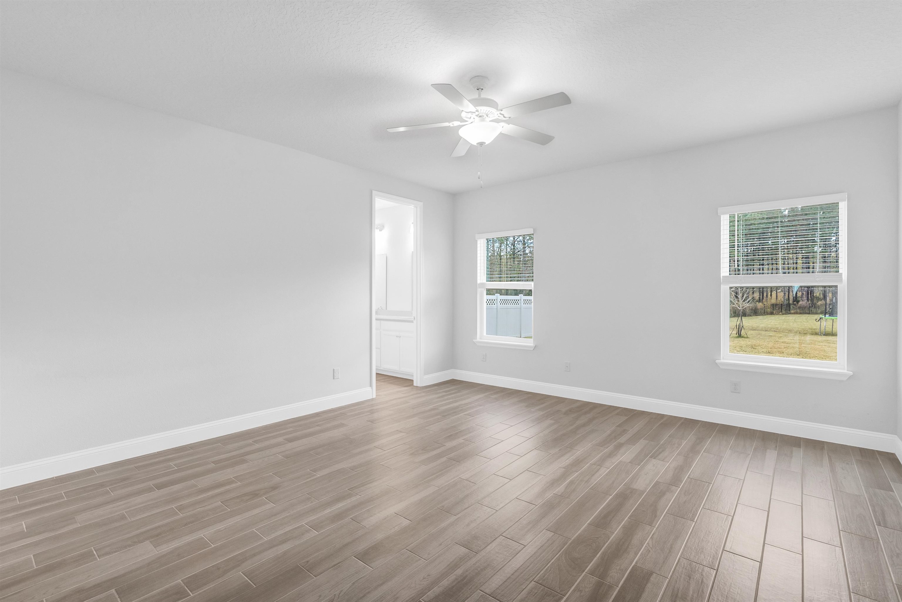75 Pine Candle Way St. Augustine, FL 32092 - Photo 18 of 84 a view of an empty room with wooden floor and a window