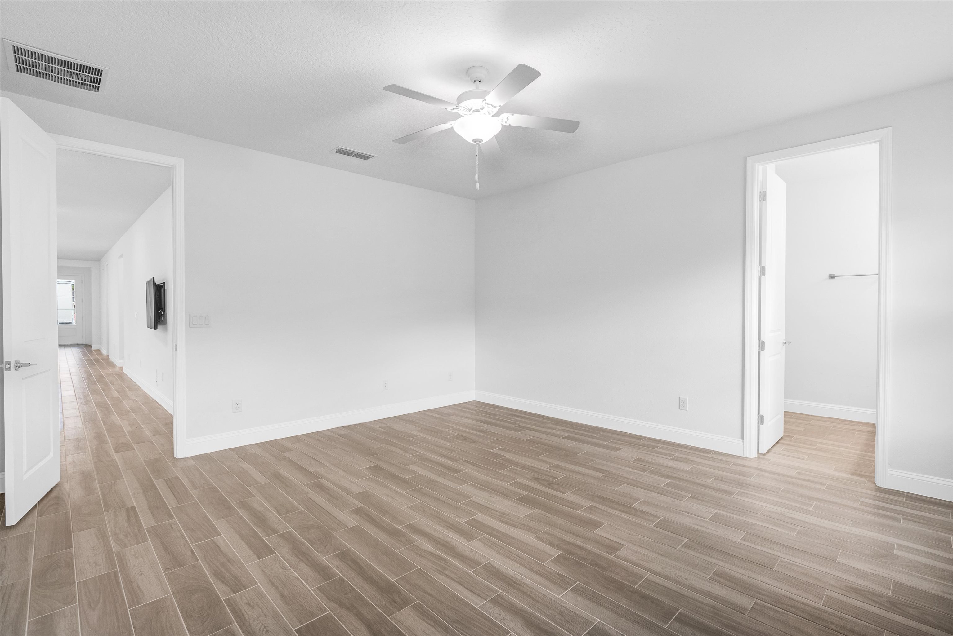 75 Pine Candle Way St. Augustine, FL 32092 - Photo 19 of 84 an empty room with wooden floor and a ceiling fan