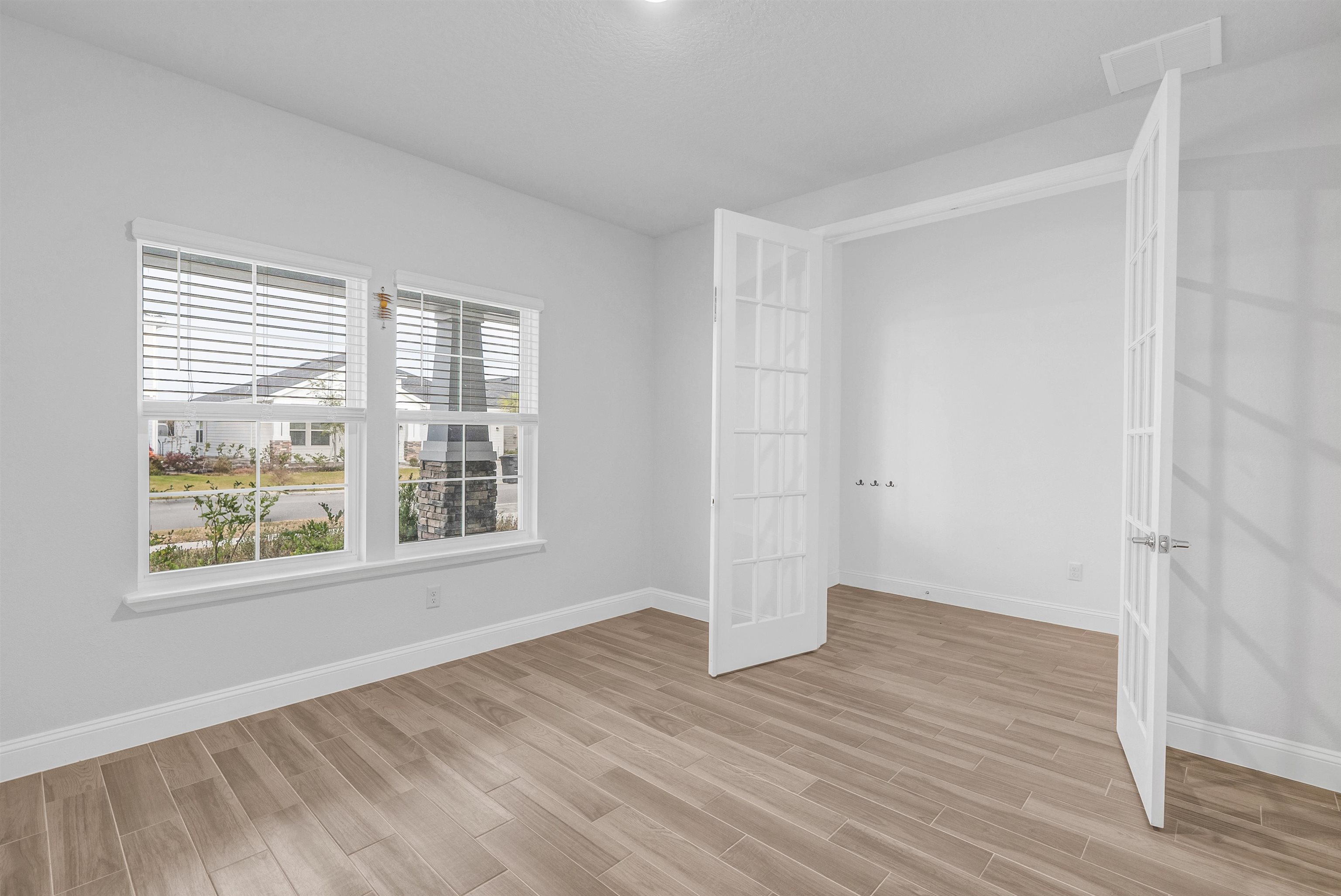 75 Pine Candle Way St. Augustine, FL 32092 - Photo 21 of 84 a view of an empty room with wooden floor and a window