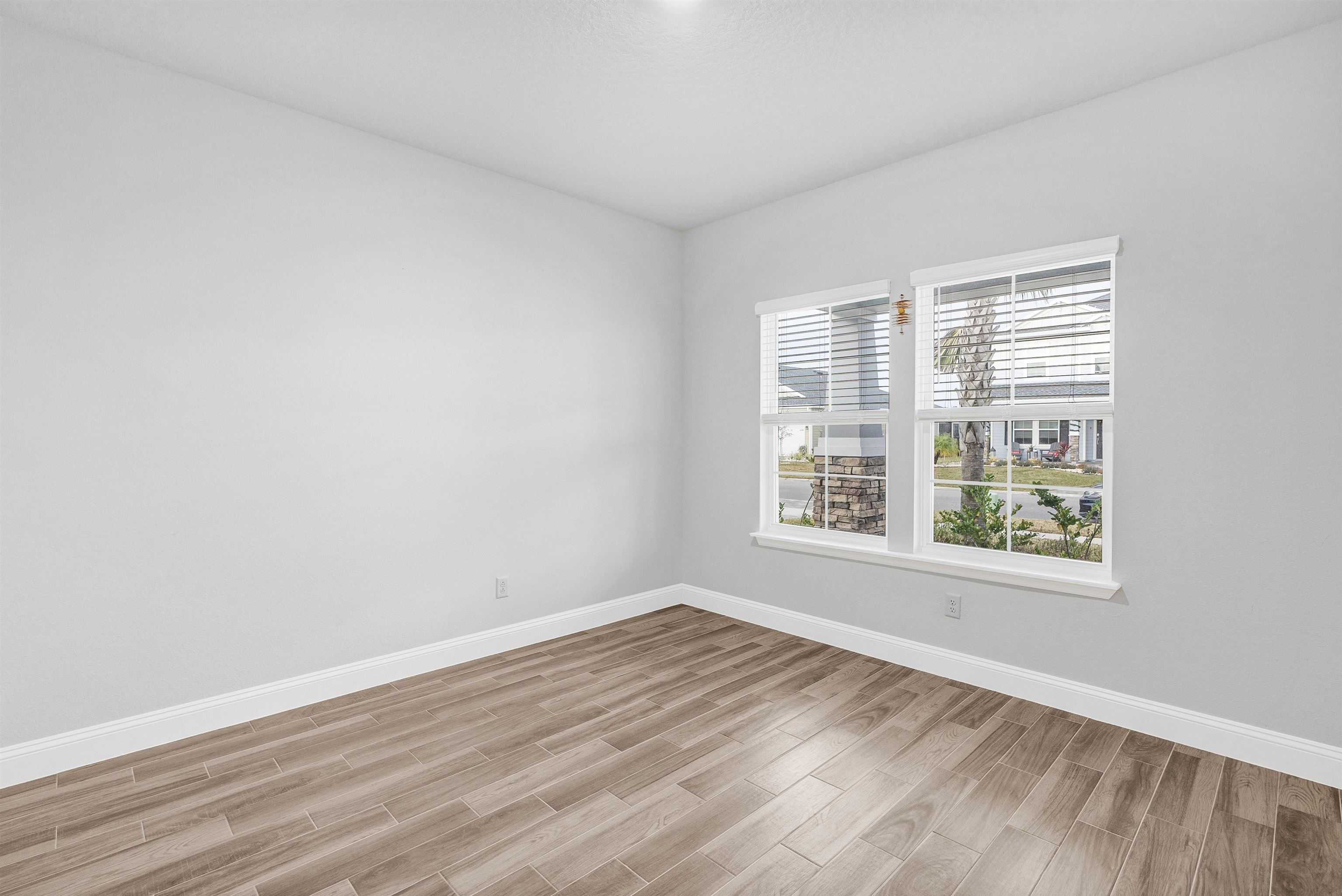 75 Pine Candle Way St. Augustine, FL 32092 - Photo 22 of 84 an empty room with wooden floor and windows