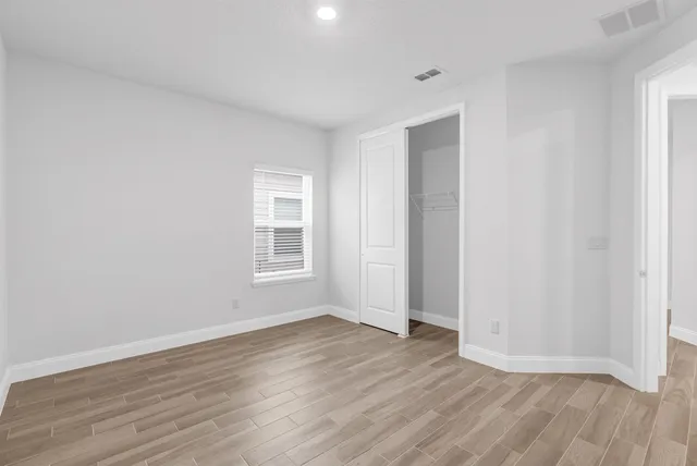 a front view of a house with a garden and plants