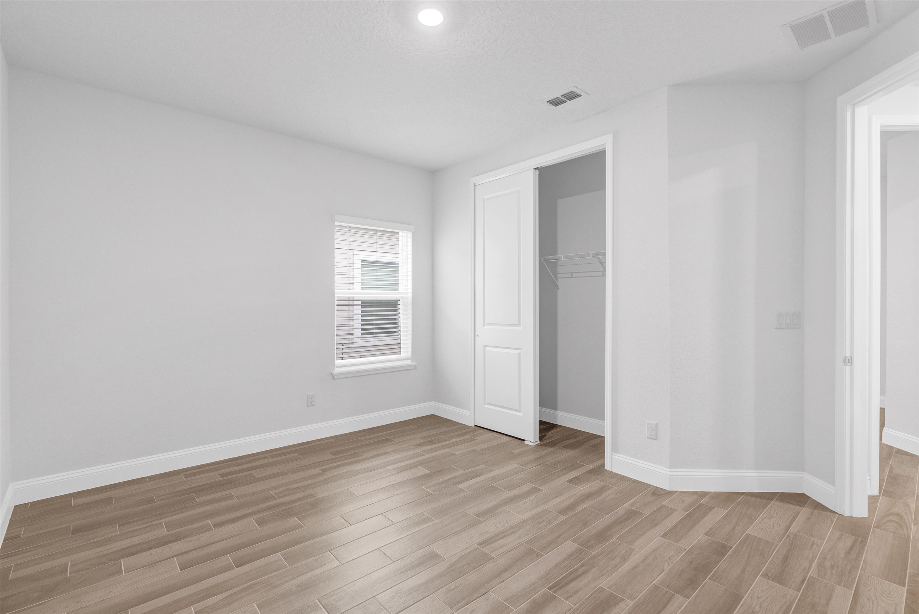 75 Pine Candle Way St. Augustine, FL 32092 - Photo 26 of 84 a view of an empty room with wooden floor and a window