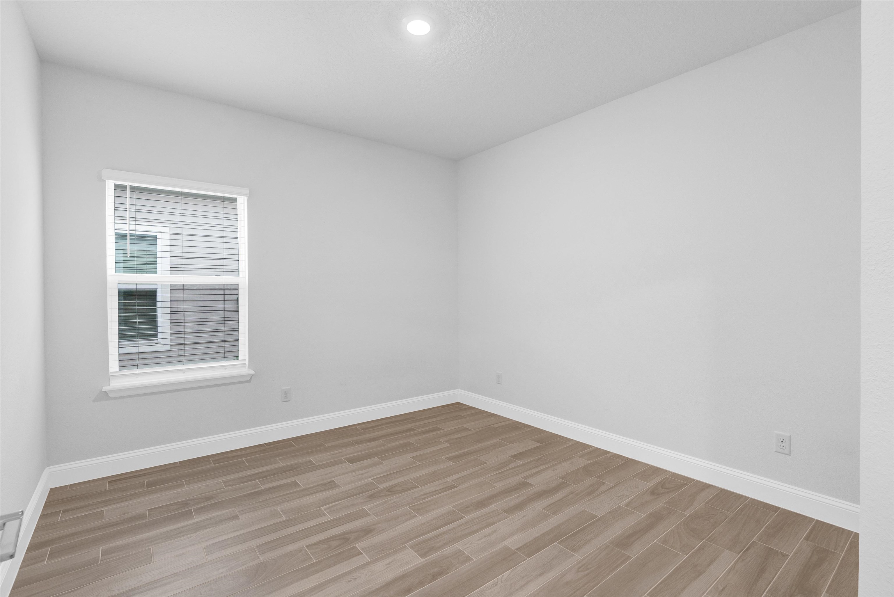 75 Pine Candle Way St. Augustine, FL 32092 - Photo 27 of 84 an empty room with wooden floor and windows