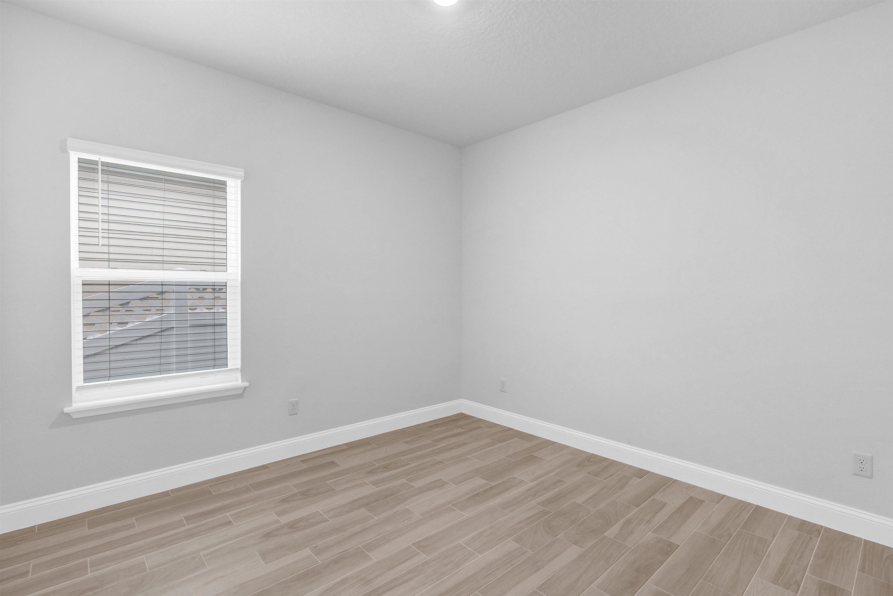 75 Pine Candle Way St. Augustine, FL 32092 - Photo 29 of 84 a view of an empty room with wooden floor and a window