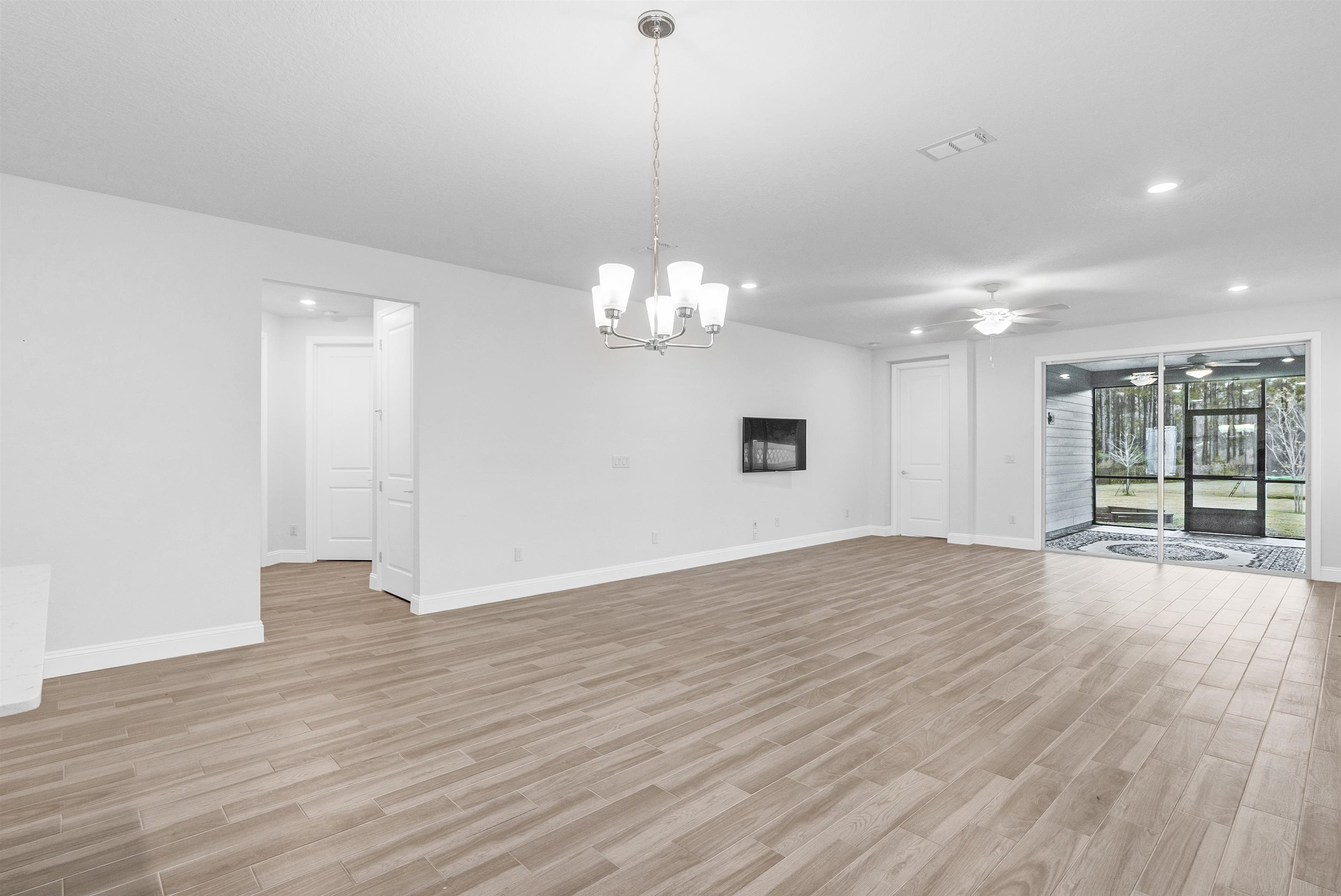 75 Pine Candle Way St. Augustine, FL 32092 - Photo 31 of 84 a view of an empty room with wooden floor and a window