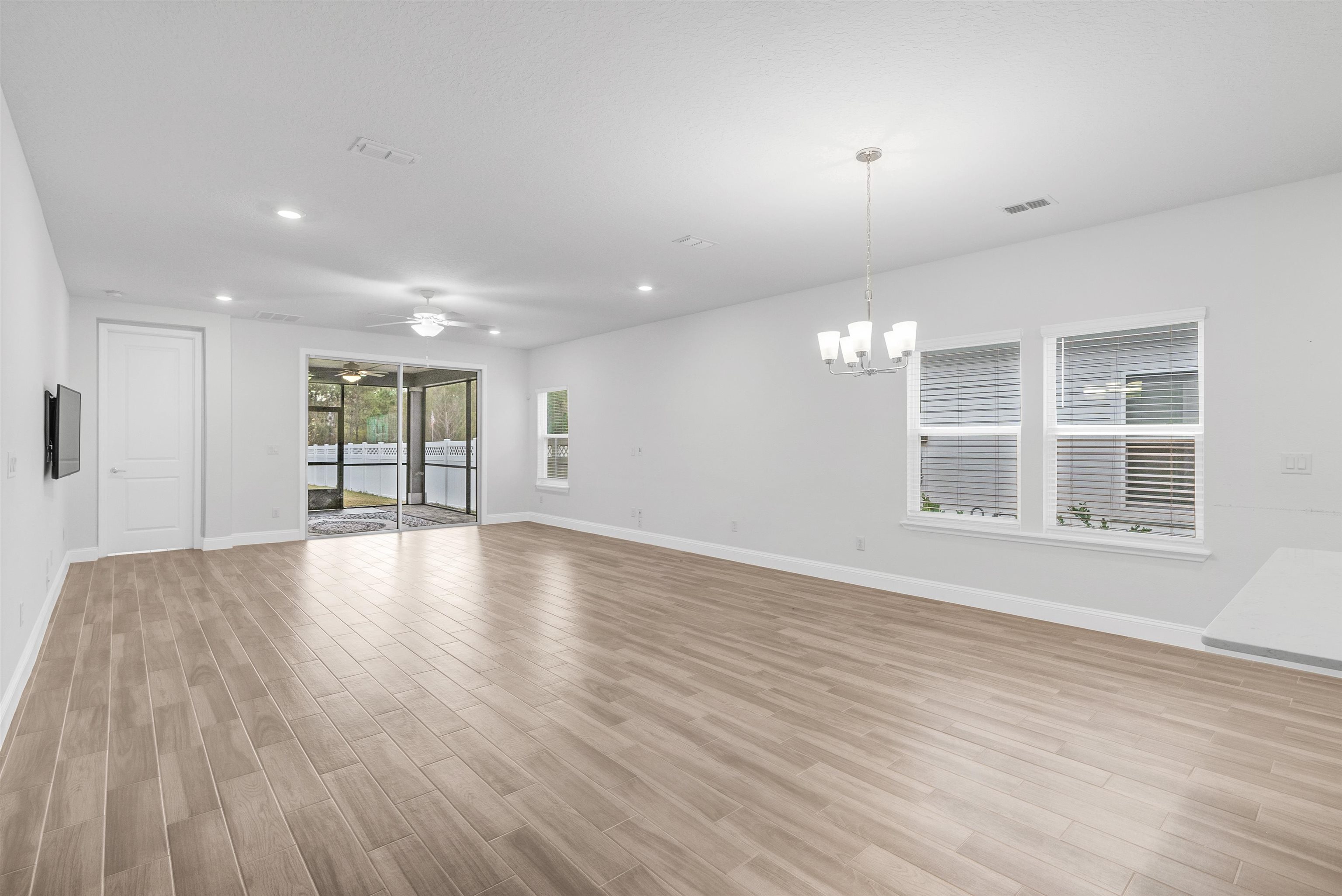 75 Pine Candle Way St. Augustine, FL 32092 - Photo 32 of 84 a view of an empty room with wooden floor and a window