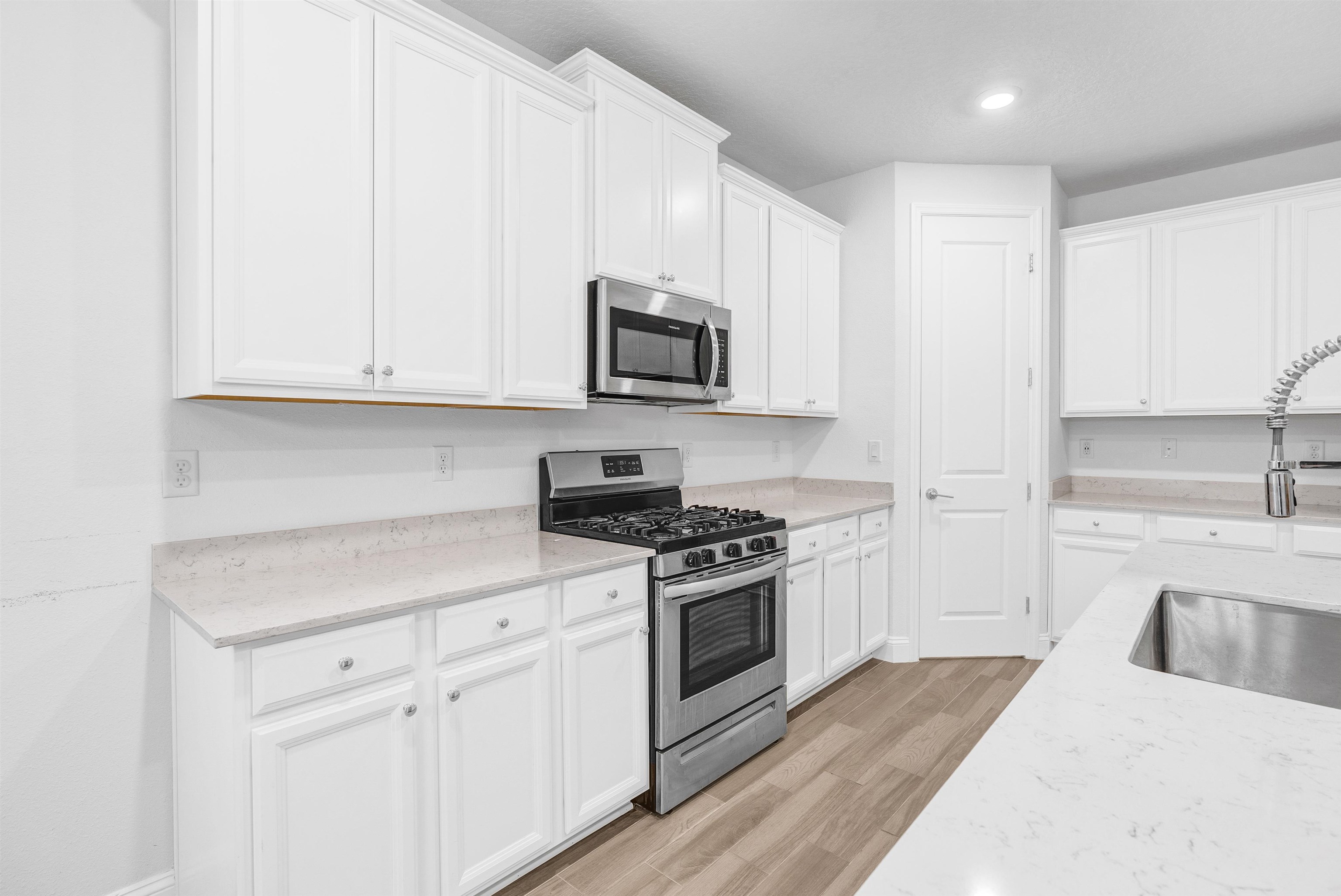 75 Pine Candle Way St. Augustine, FL 32092 - Photo 4 of 84 a kitchen with stainless steel appliances granite countertop a stove a sink and a microwave