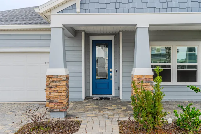 a view of a swimming pool with a table and chairs under an umbrella