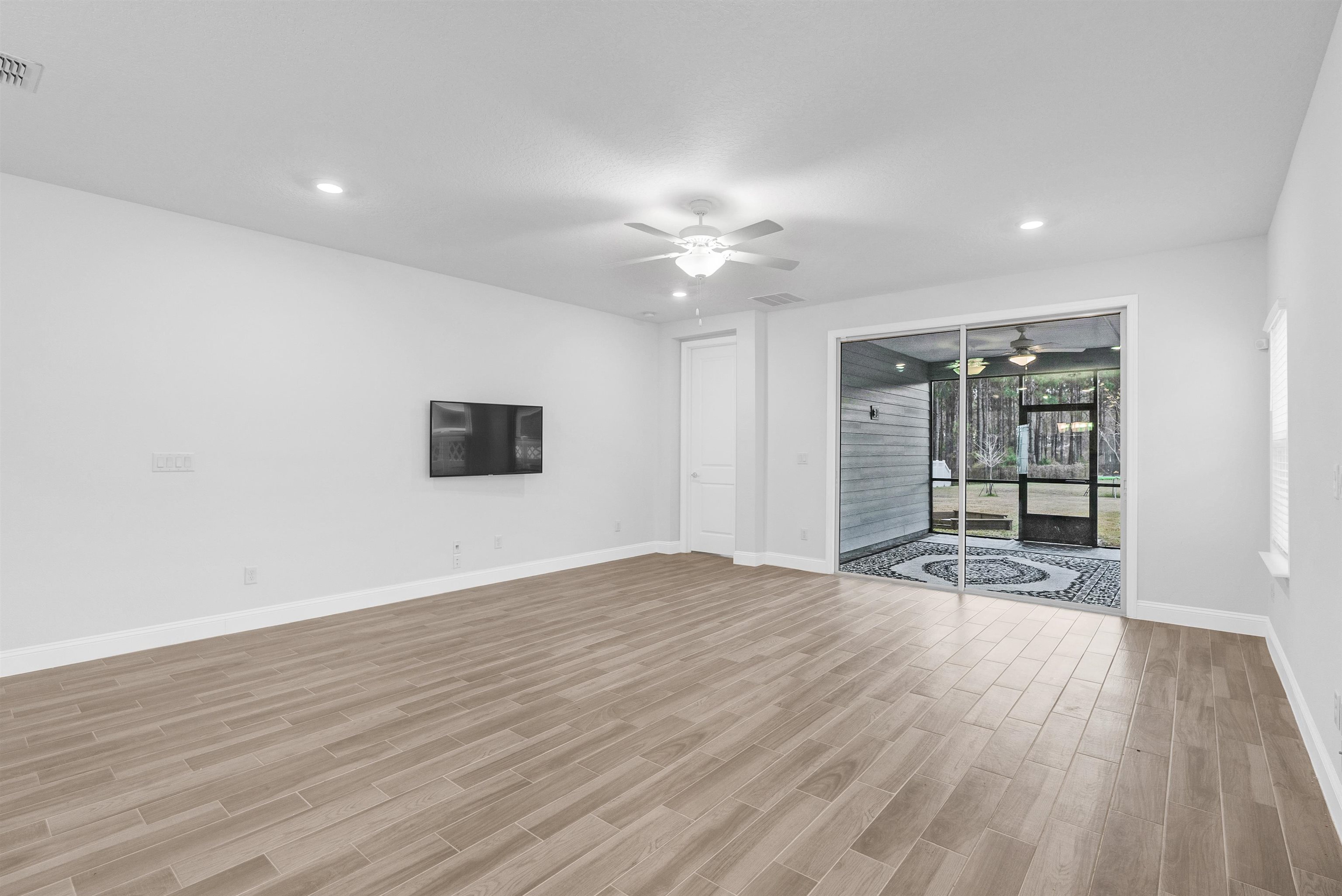 75 Pine Candle Way St. Augustine, FL 32092 - Photo 10 of 84 a view of an empty room with a window and wooden floor