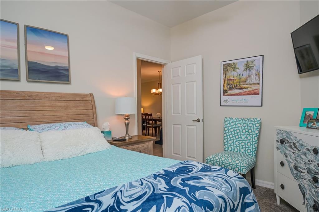 1803 Alameda Drive Naples, FL 34120 - Photo 15 of 30 a bedroom with a bed and a painting on the wall