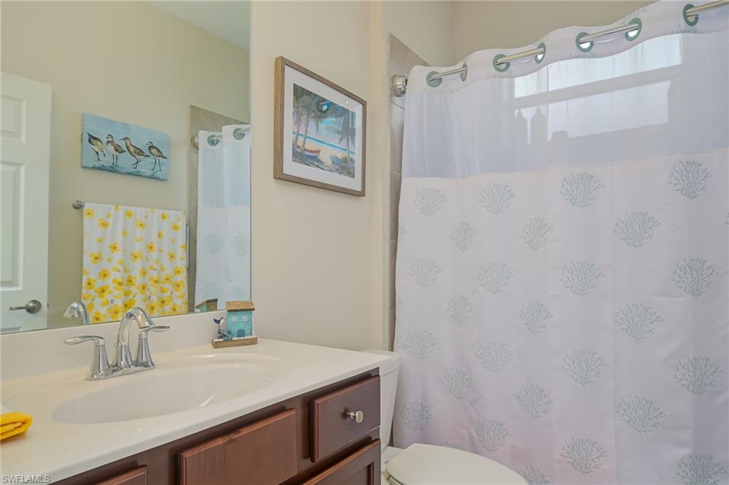 1803 Alameda Drive Naples, FL 34120 - Photo 16 of 30 a bathroom with a sink vanity mirror and toilet