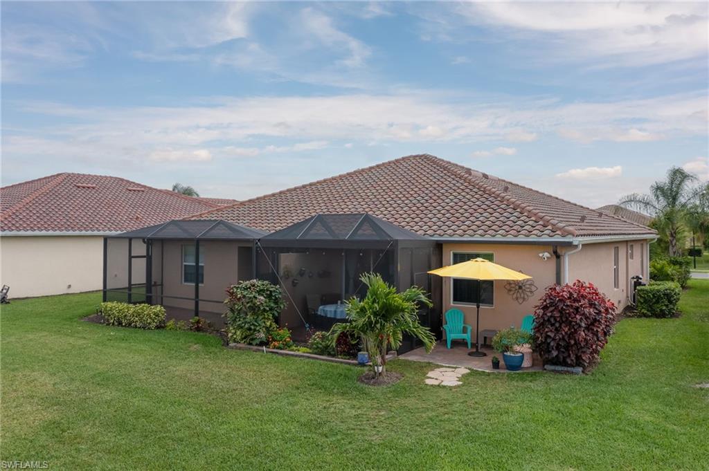 1803 Alameda Drive Naples, FL 34120 - Photo 23 of 30 a view of a house with a yard and a garden