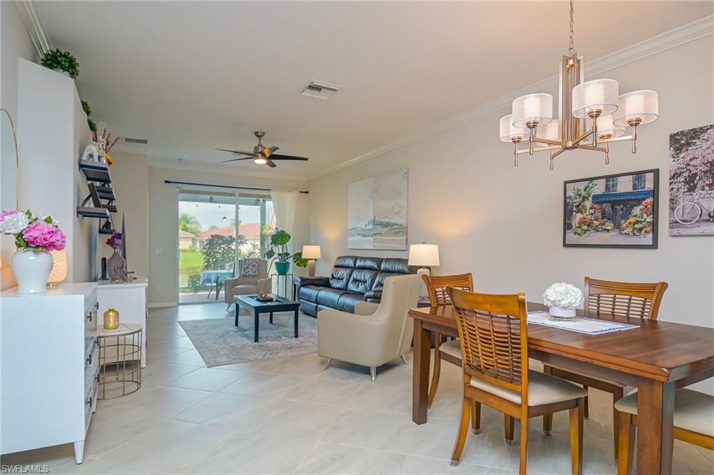 1803 Alameda Drive Naples, FL 34120 - Photo 3 of 30 a view of a dining room with furniture and a chandelier