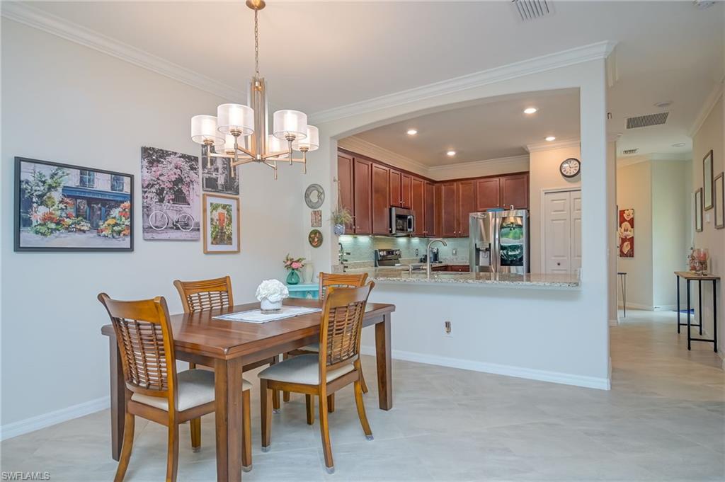 1803 Alameda Drive Naples, FL 34120 - Photo 6 of 30 a dining room filled chandelier and kitchen view