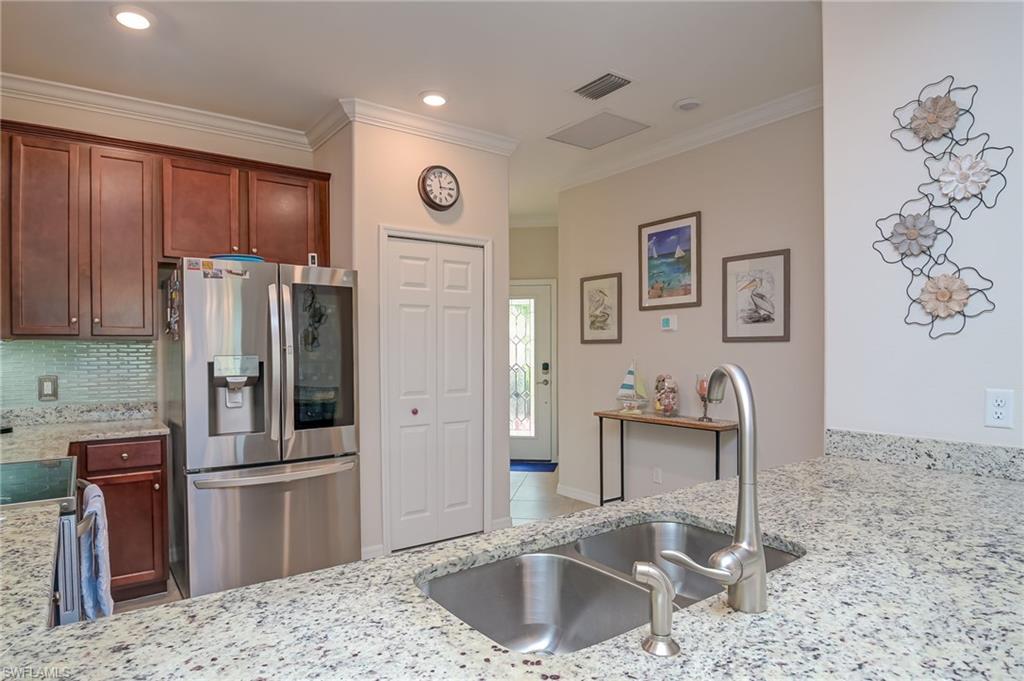 1803 Alameda Drive Naples, FL 34120 - Photo 7 of 30 a kitchen with stainless steel appliances granite countertop a refrigerator and a sink