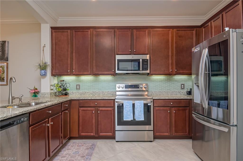 1803 Alameda Drive Naples, FL 34120 - Photo 8 of 30 a kitchen with a sink stove and refrigerator