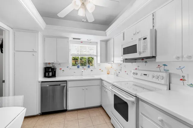 a kitchen with white cabinets sink and white appliances