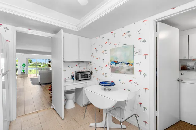 a kitchen with stainless steel appliances a refrigerator a stove a sink and white cabinets with wooden floor