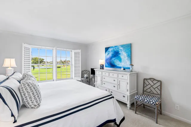 a bed room with a bed window and a chair