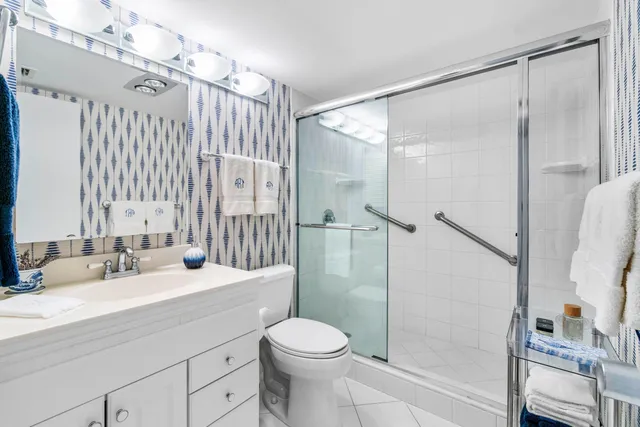 a bathroom with a sink toilet and shower