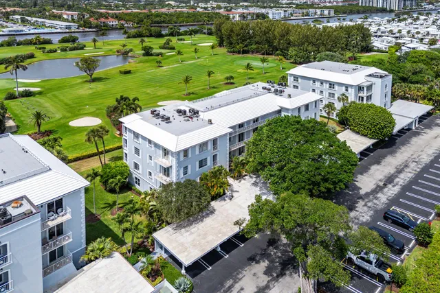 an aerial view of multiple houses with yard