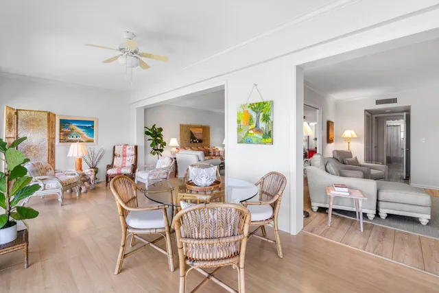 a living room with furniture and painting on the wall