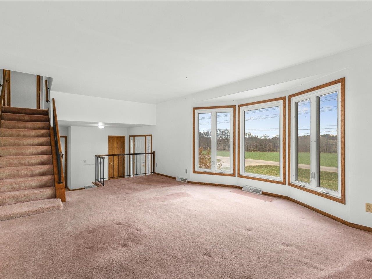 2110 East Angle Road Dakota, IL 61018 - Photo 14 of 47 a view of an empty room with a fireplace and a large window